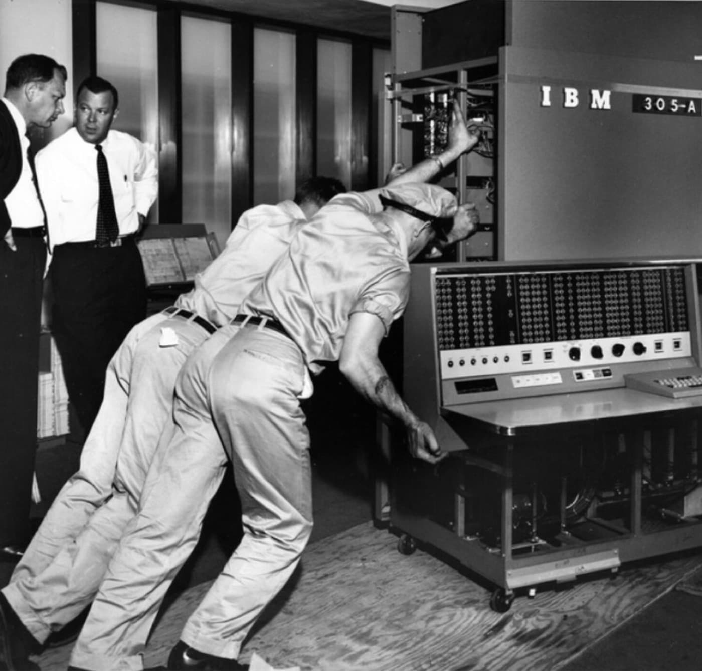 A team moving an early IBM computer into place.
